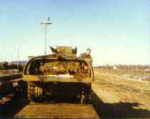 Tracked Army vehicle secured on a railcar during the return from REFORGER 85