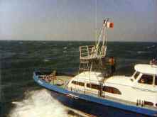 Small vessel running beside the American Eagle in the Atlantic