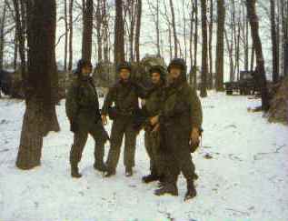 Four soldiers standing together in the snow during REFORGER 85