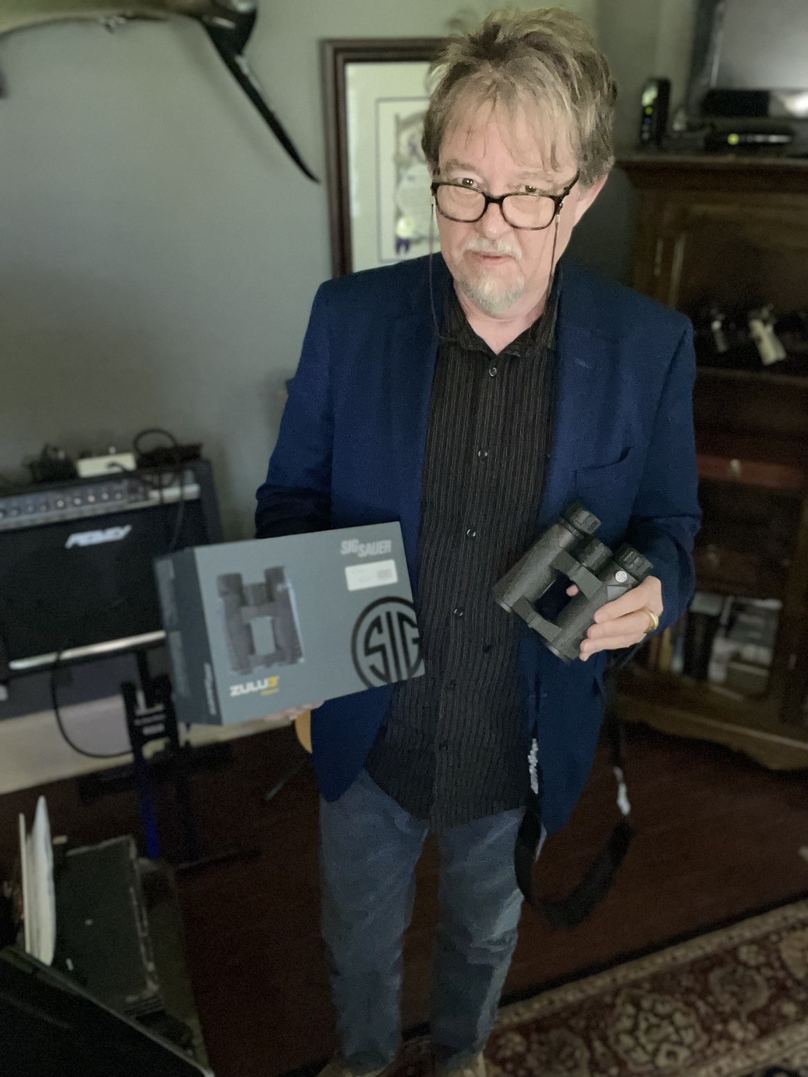 author holding granddaughter's sig sauer binoculars