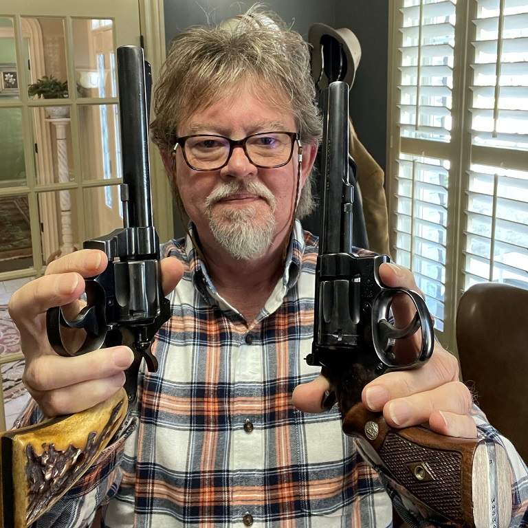 Author holding a 1950 Officers Model Special and K-22 Masterpiece