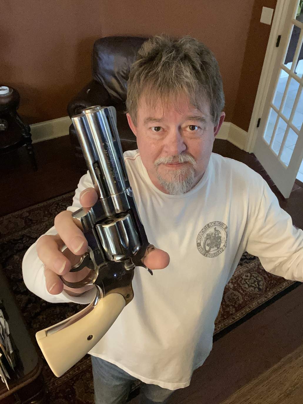 author holding old colt python up to camera