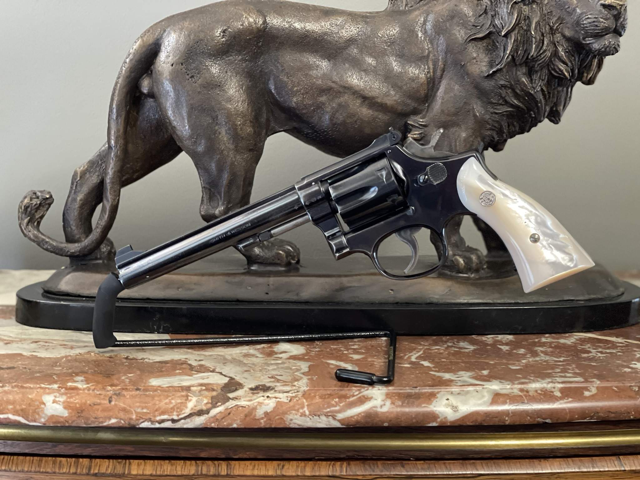 Blued Smith & Wesson K-22 style target K-Frame revolver with mother-of-pearl stocks, long barrel, adjustable sight, and S&W medallion grips