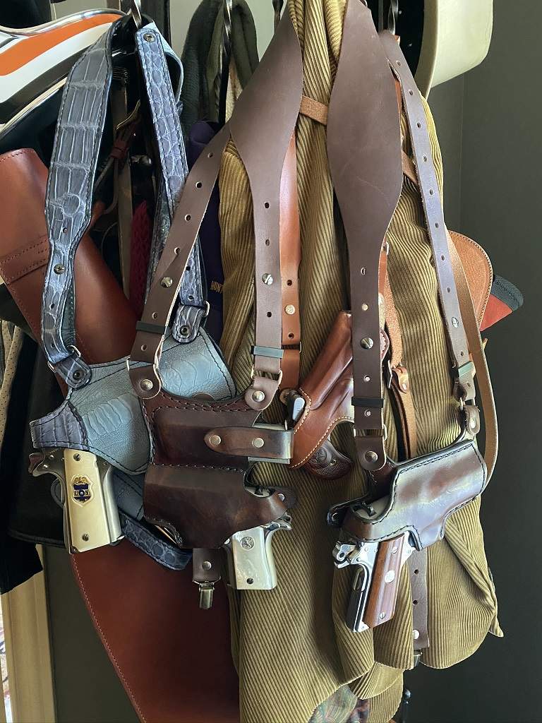 Southern Trapper, Bob Mernickles and Guns Leather Etc shoulder holsters hanging on coat rack