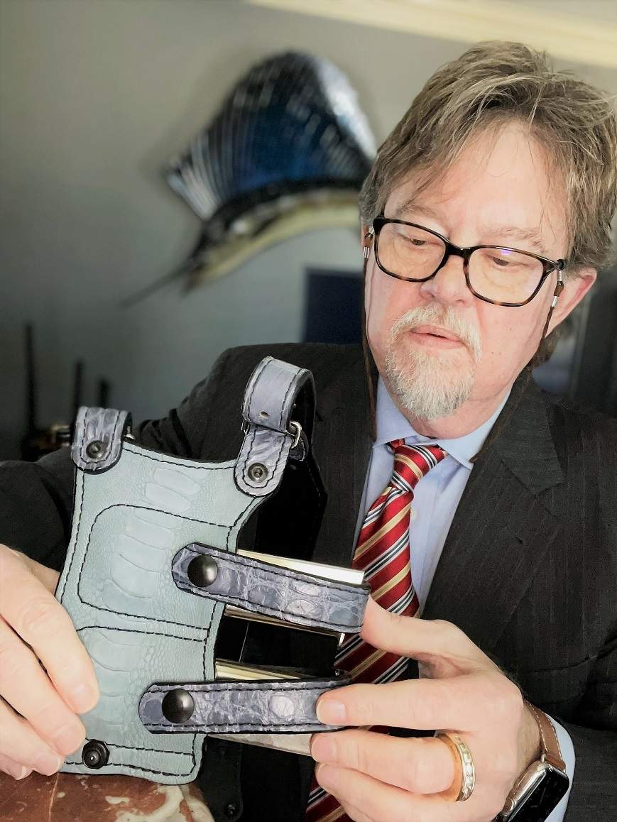 Author inspecting Southern Trapper shoulder holster mag carriers