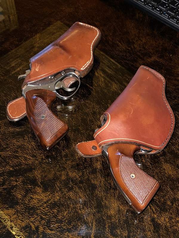 two revolvers in holsters illustrating with and without trigger and hammer guards