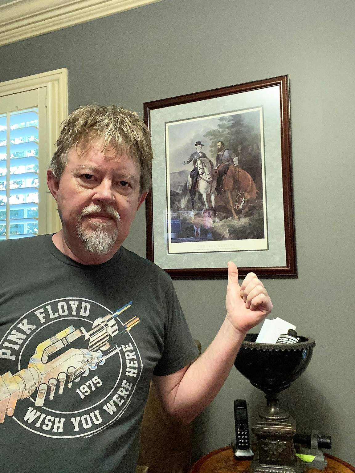 Author pointing to his picture of Robert E. Lee and Stonewall Jackson on horseback