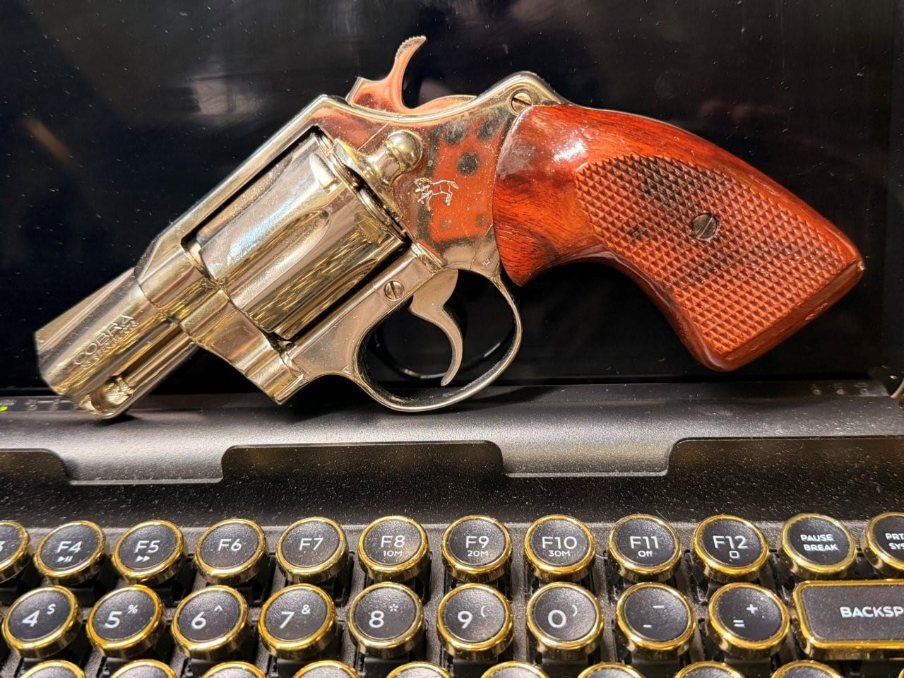Close-up view of Colt Cobra barrel marking and opened cylinder