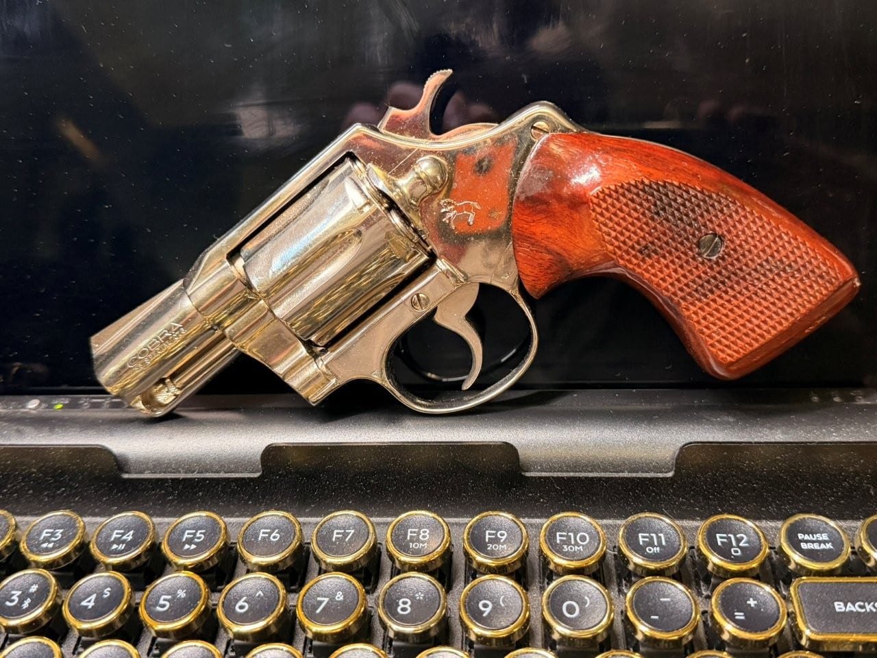 Left-side view of nickel Colt Cobra with wood stocks