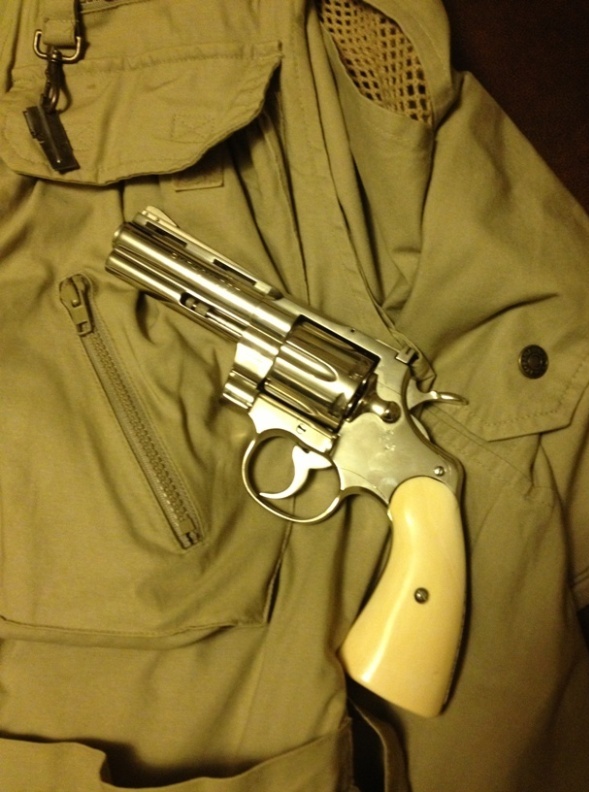 1962 Colt Python wearing period elephant ivory grips laying on hunting vest