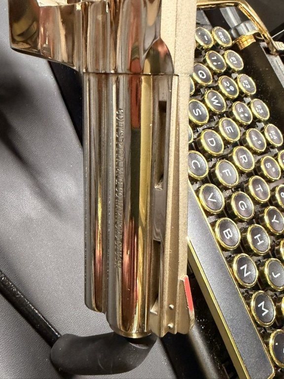 Close-up view of a modern Colt Python barrel showing the polished full underlug, ventilated rib, front sight channel, and barrel rollmark. The image helps collectors document modern Python barrel markings, sight construction, muzzle details, and finish differences from original-series Colt Python revolvers.