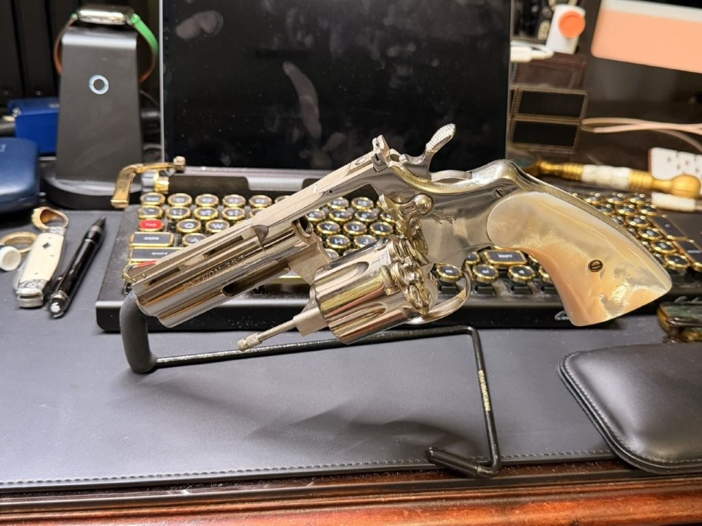 Left-side profile view of a late first-generation Colt Python from the discontinuation era. The photograph shows the ventilated rib, full underlug barrel, adjustable sights, polished finish, and classic Python profile collectors should document when verifying late Custom Shop or Python Elite-era revolvers.