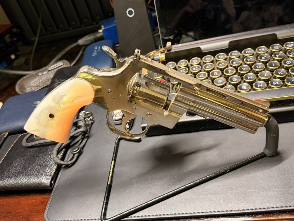 Right-side profile view of a late-production Colt Python Custom Shop revolver. The photograph shows the ventilated rib, full underlug barrel, adjustable sights, and polished finish characteristic of first-generation Python Elite and Custom Shop-era revolvers produced during the final years of original Python manufacture.