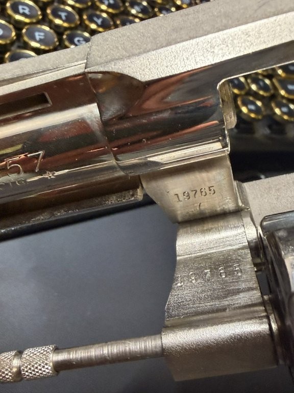 Close-up view of a Colt Python serial number stamped on the frame and crane. The matching numbers shown on both components help collectors verify originality and identify the correct serial-prefix era for the revolver.