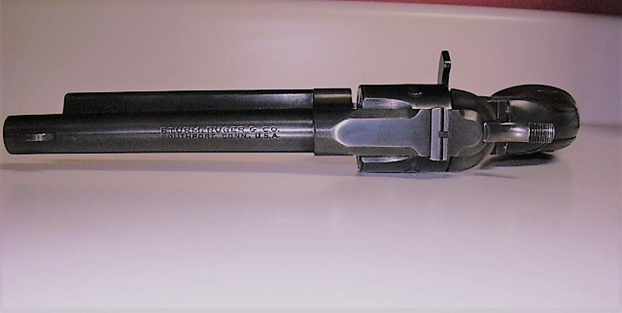 1955 Ruger Single Six laying on its side showing the open flat loading gate
