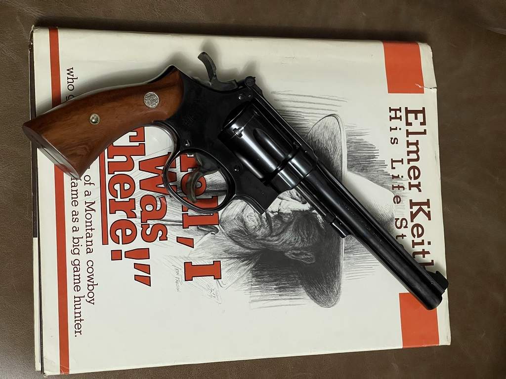 1946 K-22 Masterpiece laying on a copy of Elmer Keith's book Hell I Was There