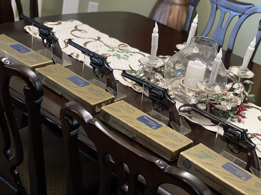 A group of boxed Smith and Wesson K-22 Masterpiece revolvers displayed together