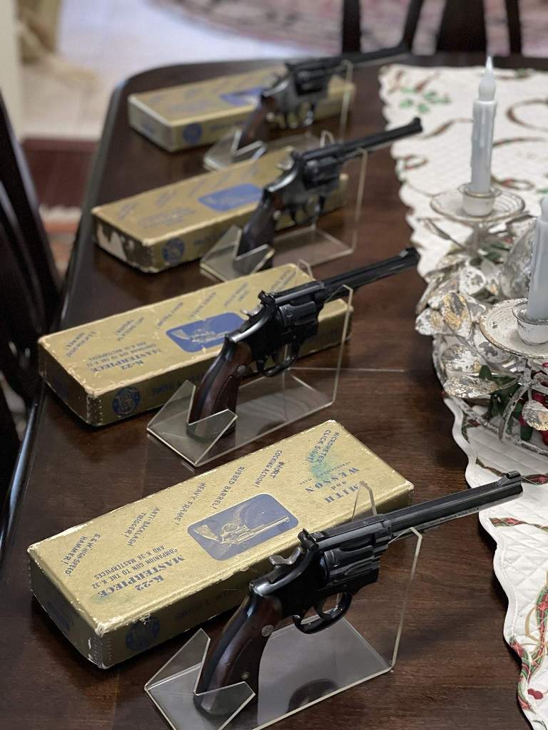 K-22 Masterpiece revolvers arranged above their Smith and Wesson boxes