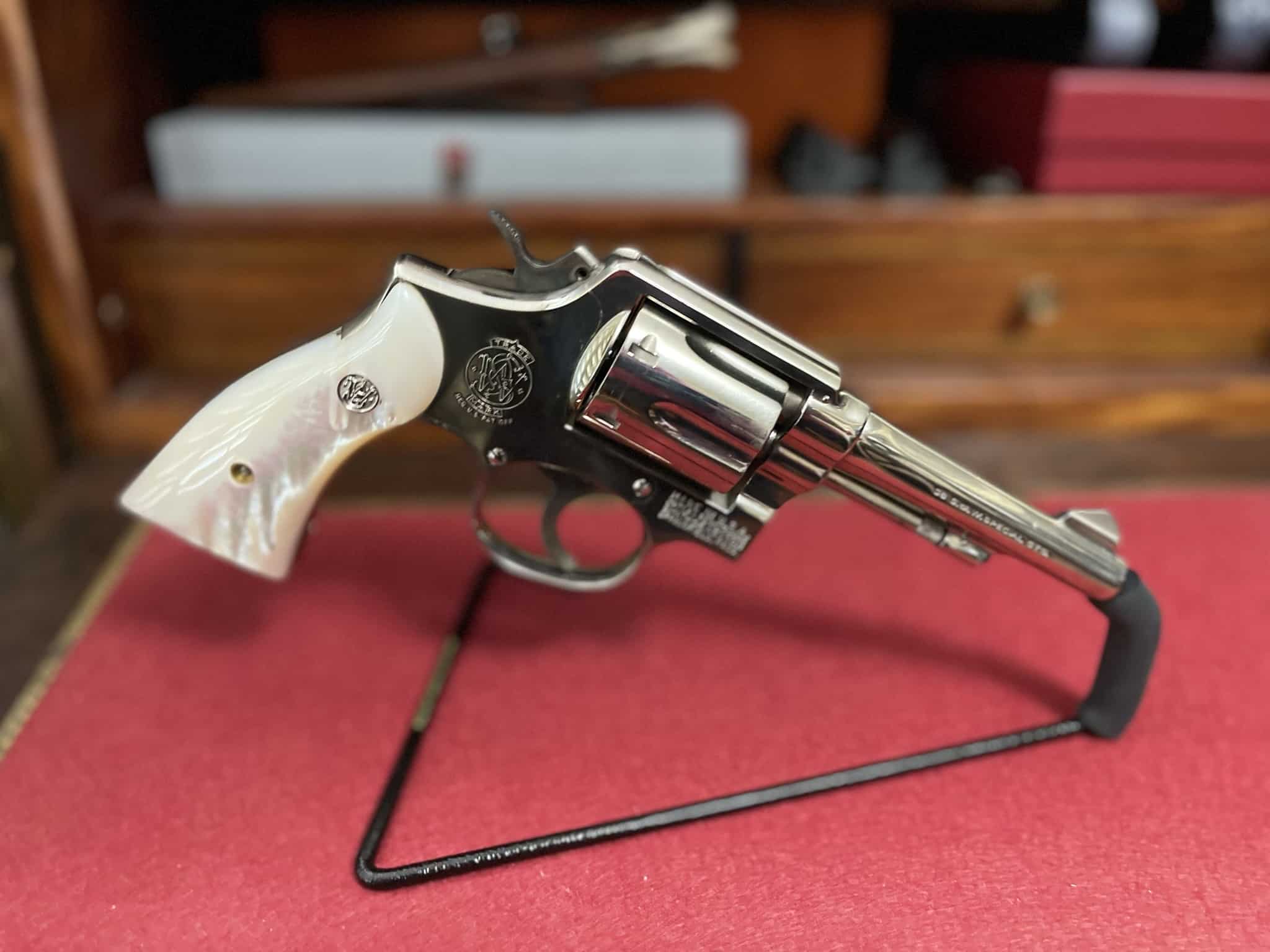 Right side view of a Smith & Wesson Model 10 revolver with pearl-style stocks
