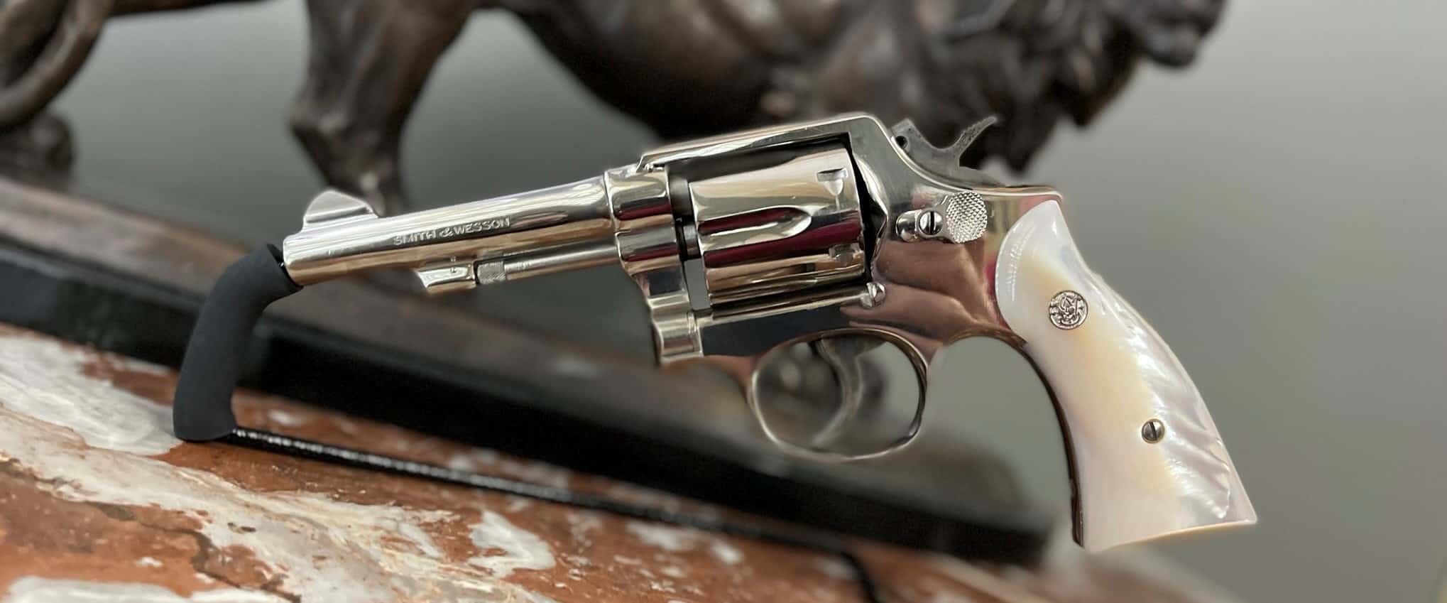 Nickel Smith & Wesson Model 10 revolver displayed with pearl-style grips