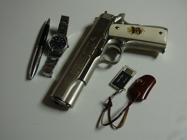 1911 Colt Government Model with watch, pen and usb drive