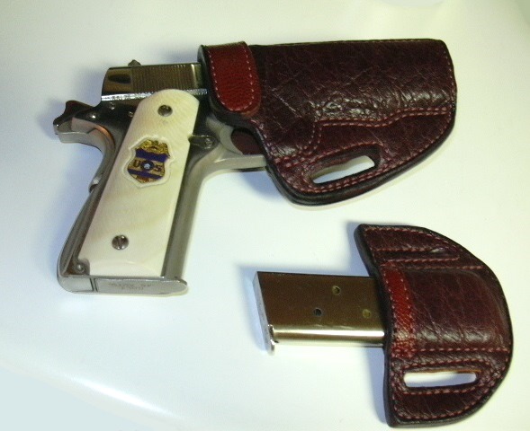 1911 Colt Government Model in holster, along with extra magazine in holster