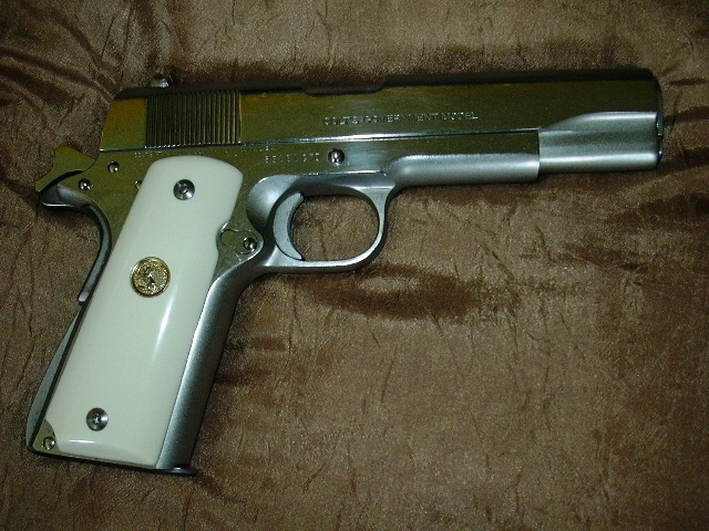 1911 Colt Government Model on gold colored cushion