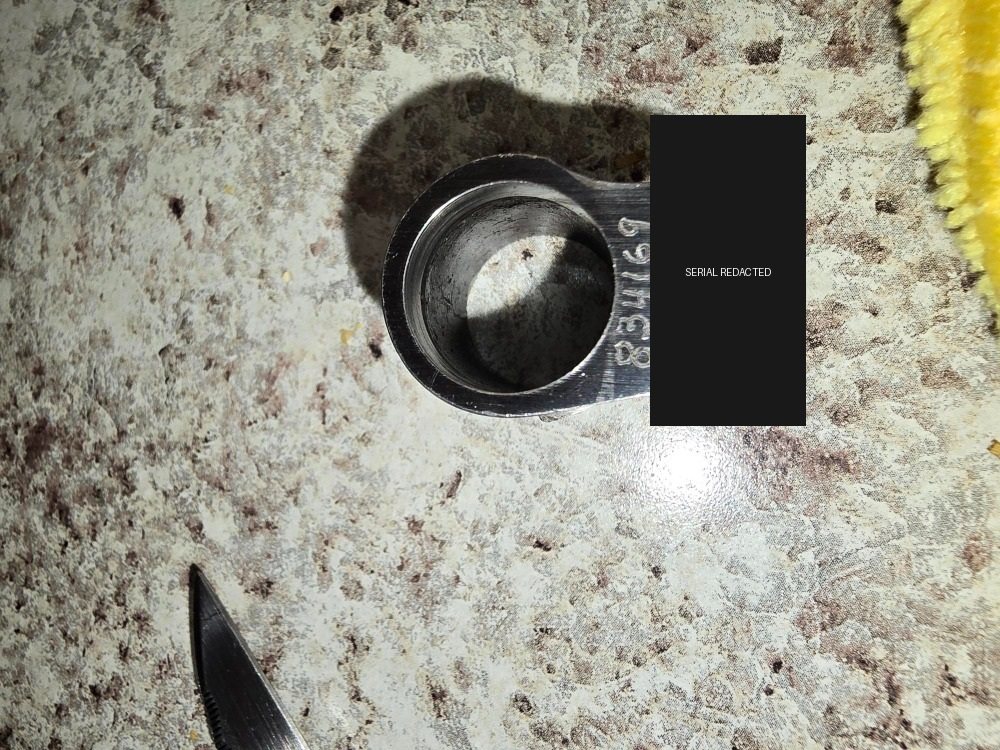 Fitted barrel bushing with identifying number covered