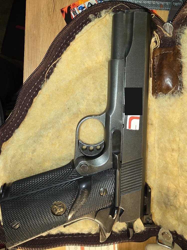 Left side of Newt Taylor Colt match pistol with identifying number covered