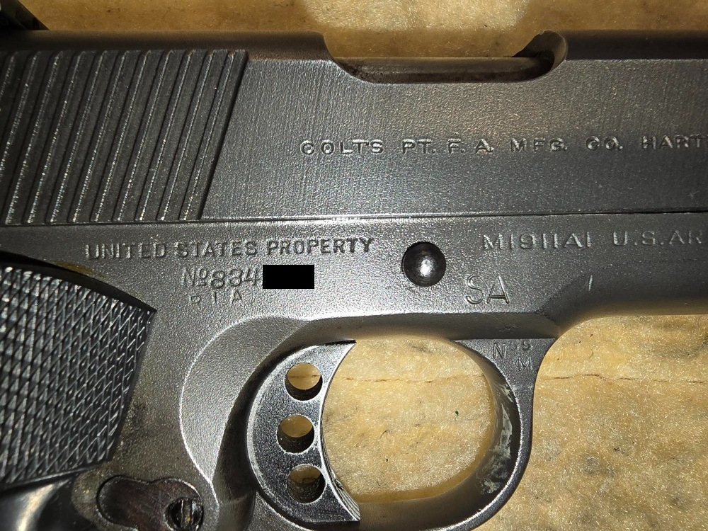 Close-up of Rock Island Arsenal RIA and Springfield Armory SA markings on the Taylor Colt frame