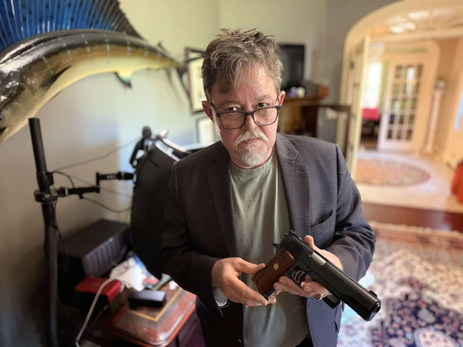Greg Cook holding his 1993 Colt Presentation Gold Cup .45 ACP