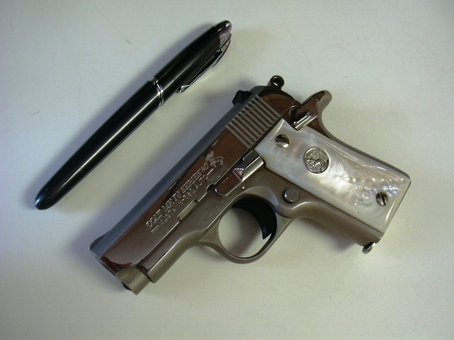 .380 Colt Mustang next to ink pen for size illustration