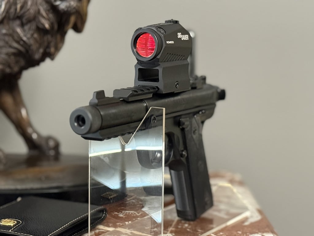 Side view of a Ruger 22 pistol on an acrylic display stand