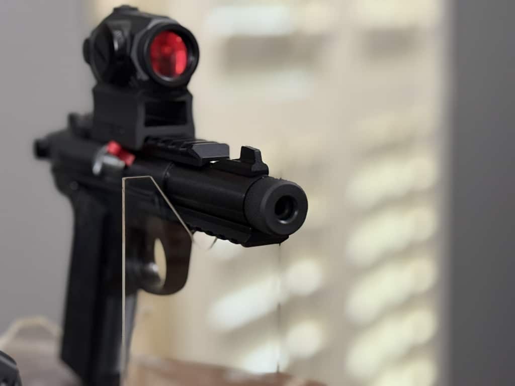 Ruger 22 pistol displayed with receiver-mounted red dot optic