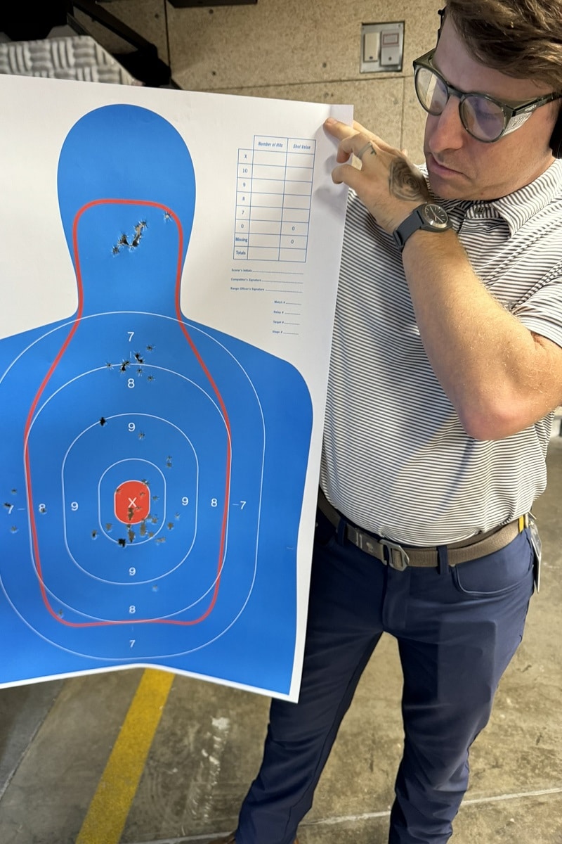 Alec with target at indoor gun range