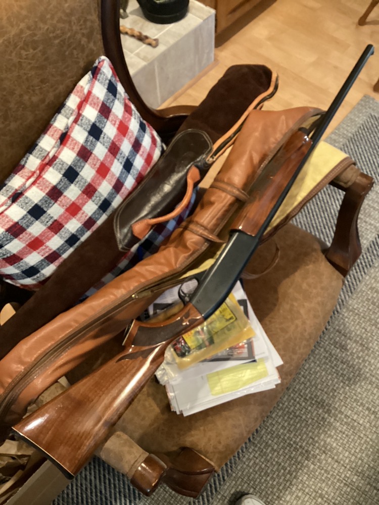 Full-length view of Gary McLain’s Remington Model 1100 beside soft gun cases